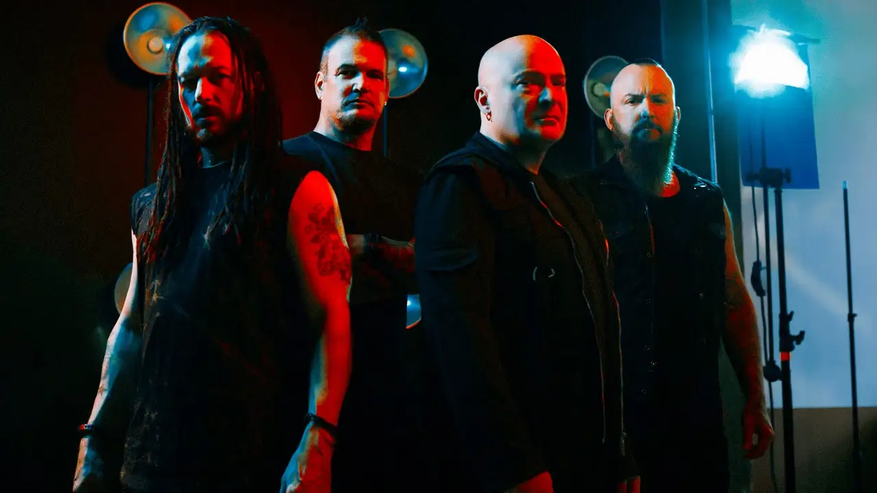 Disturbed band members posing under dramatic lighting, showcasing their signature heavy metal aesthetic.