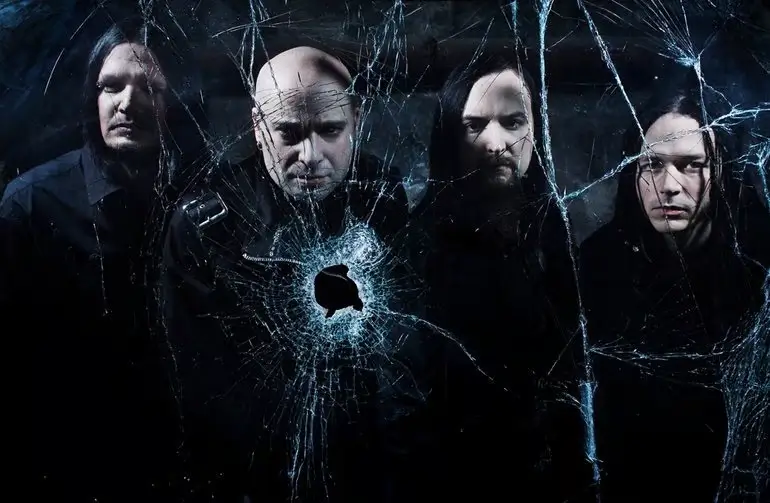 Disturbed band members posing behind a cracked glass effect, creating a dramatic and intense visual.