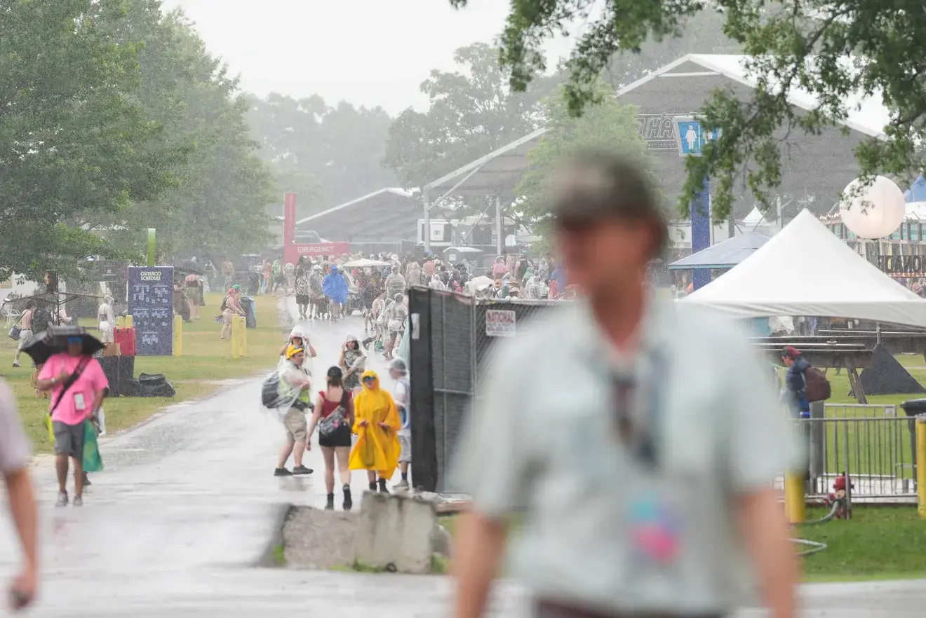 Attendees exited Centeroo on June 13, 2025, due to severe weather conditions during Bonnaroo Music and Arts Festival in Manchester, Tennessee. | Photo by Caitie McMekin / News Sentinel